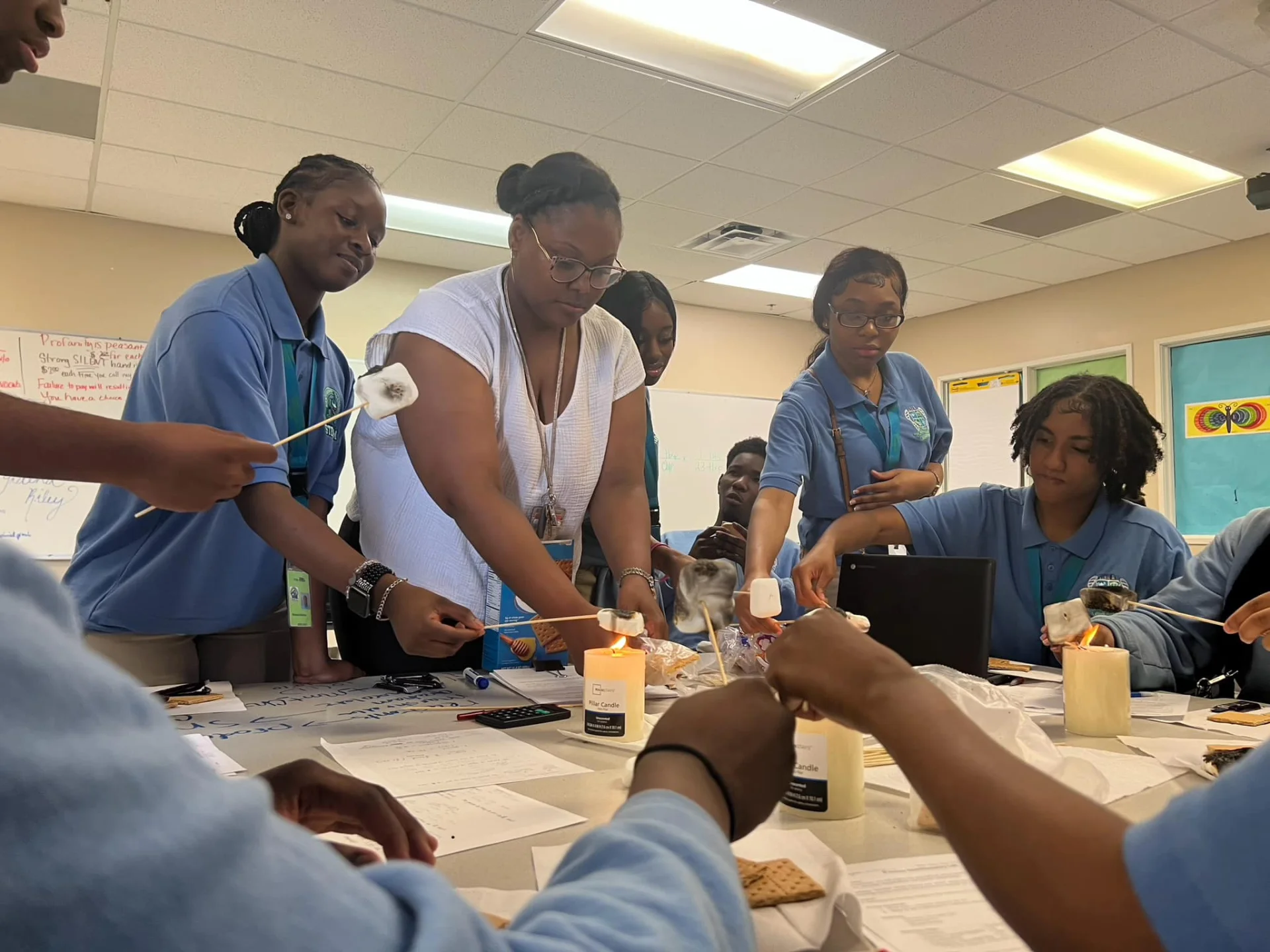 several students toasting marshmallows